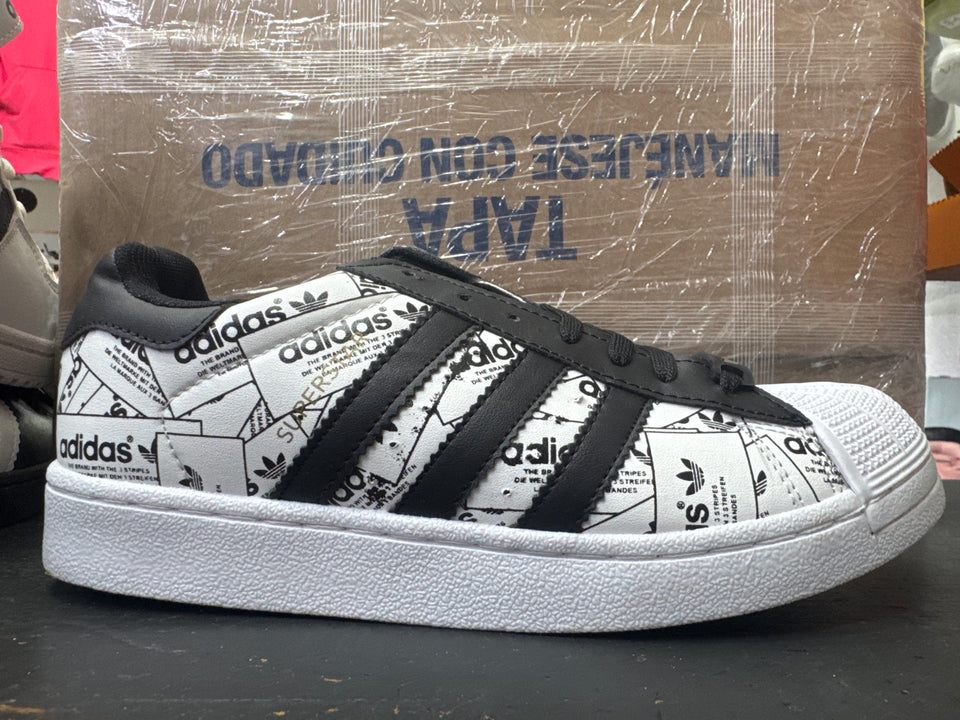 Adidas concha blanco negro periodico